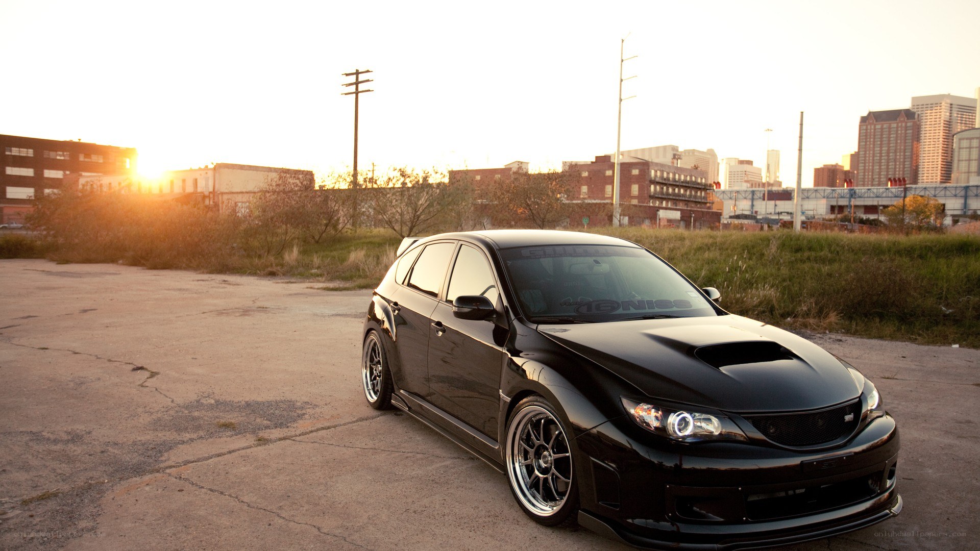 Black Subaru WRX at sunset