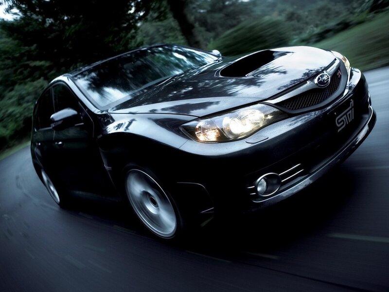 black subaru wrx sti in motion