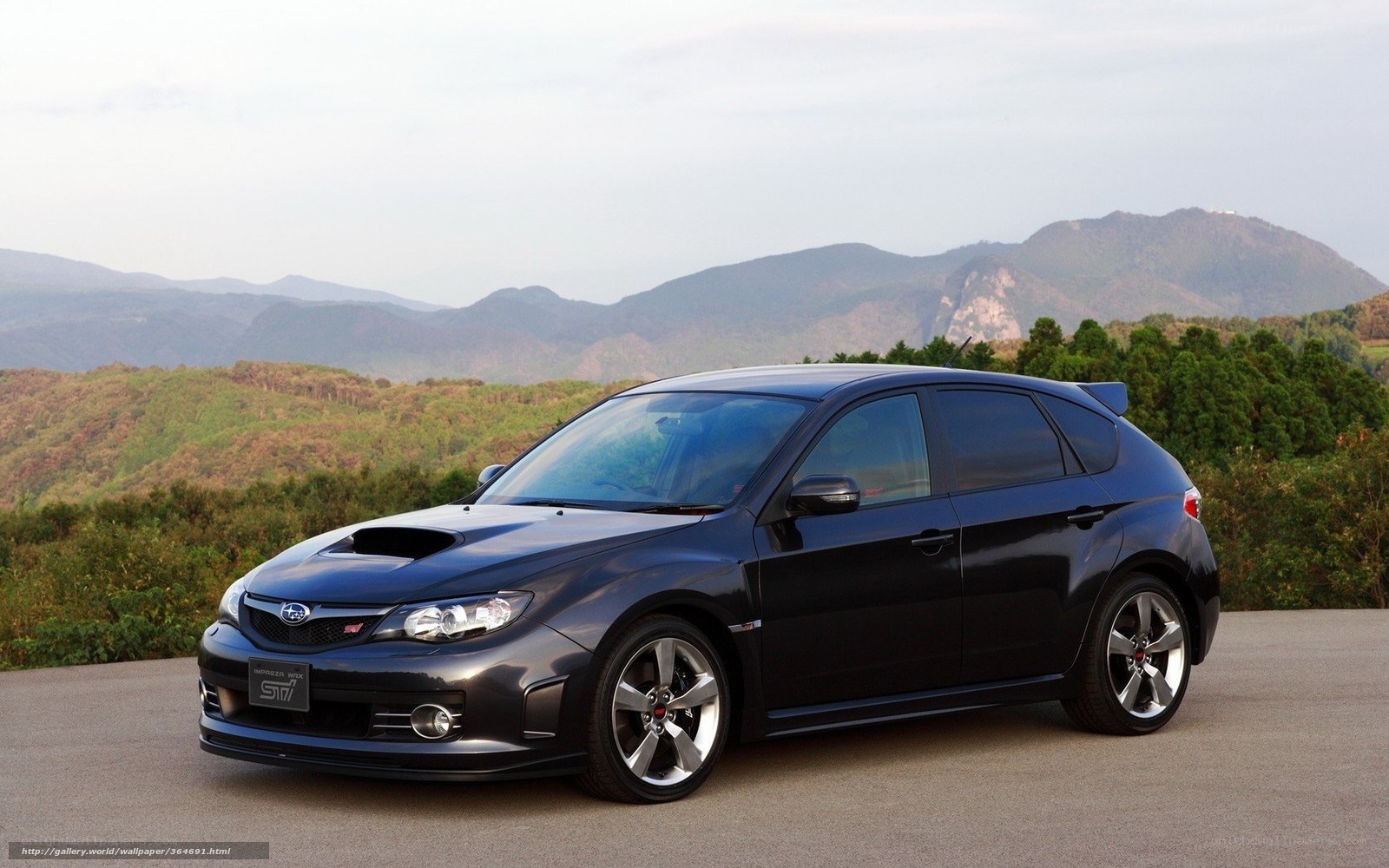 Black Subaru WRX STI on a mountain road