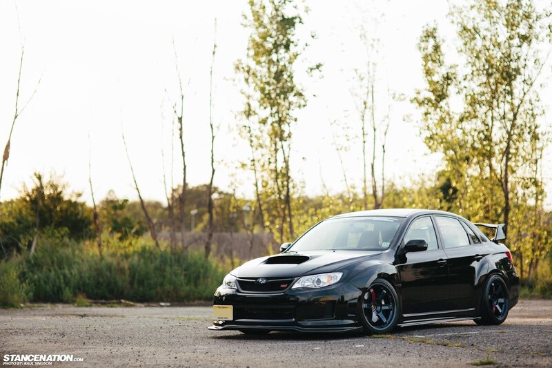 black subaru wrx sti on asphalt