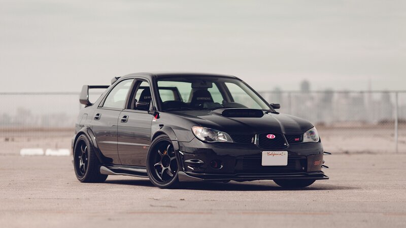 black subaru wrx sti on track