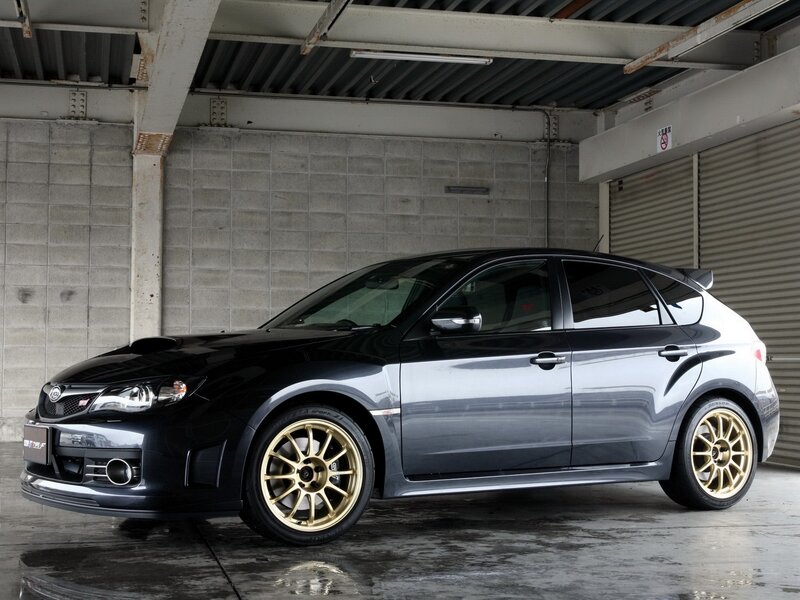 Black Subaru WRX STI with gold wheels