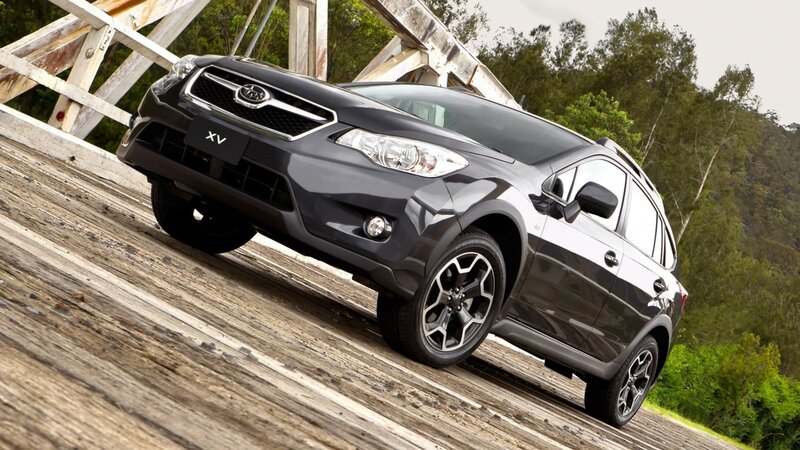Black Subaru XV on wooden bridge