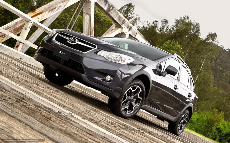 Black Subaru XV on wooden bridge
