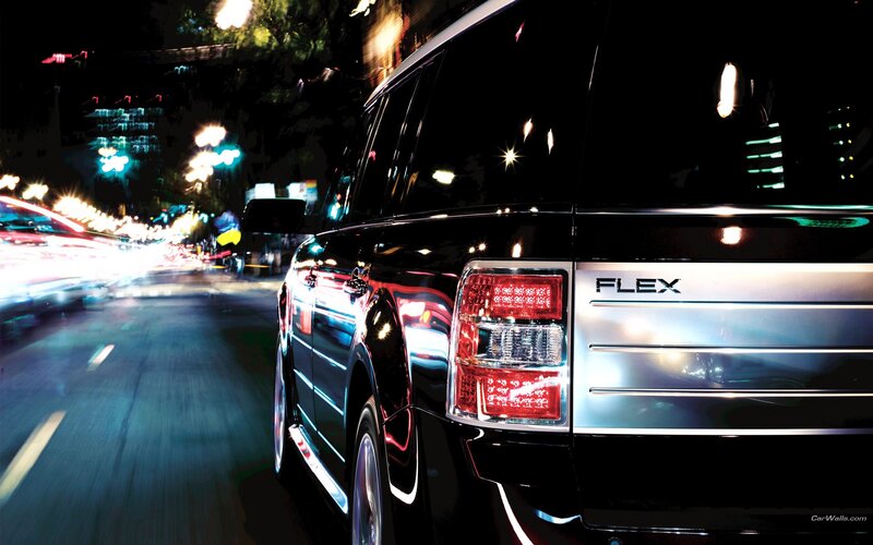 Black SUV at night on city street