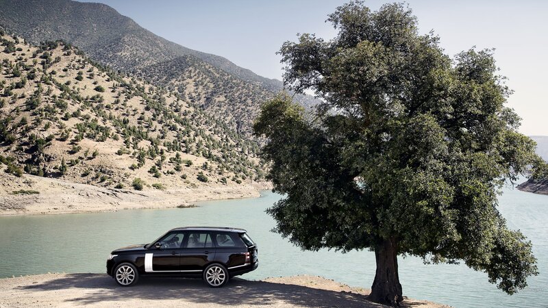 Black SUV by Lake