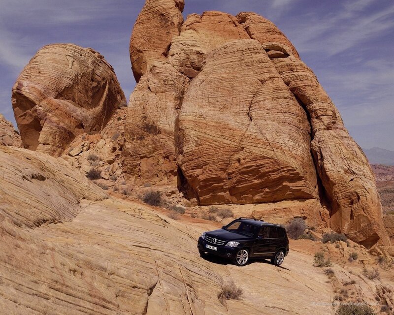Black SUV in desert canyon