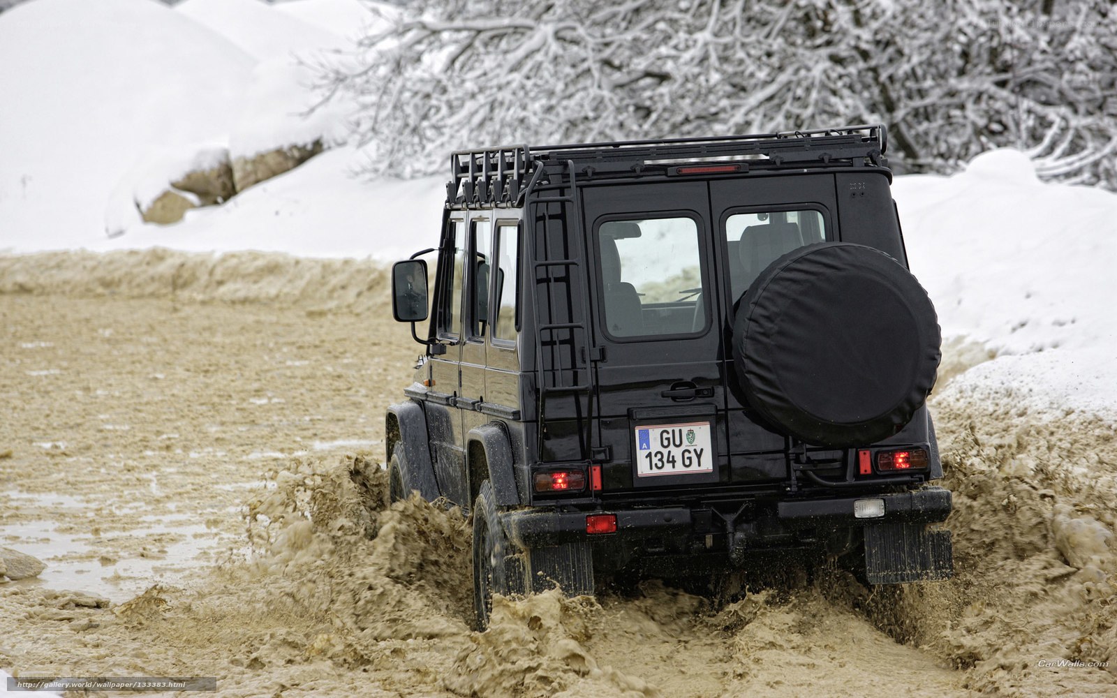 Black SUV in muddy terrain