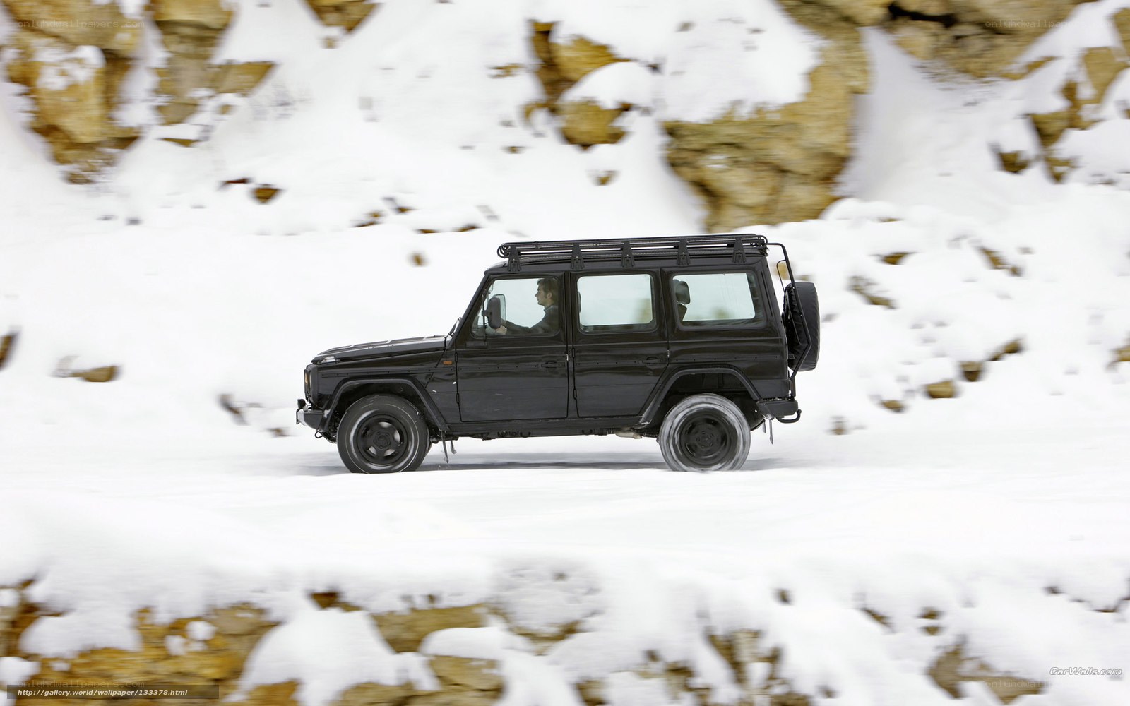 Black SUV in snowy landscape