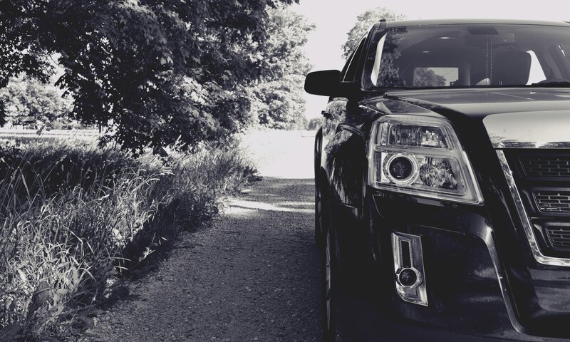 Black SUV on a rural path