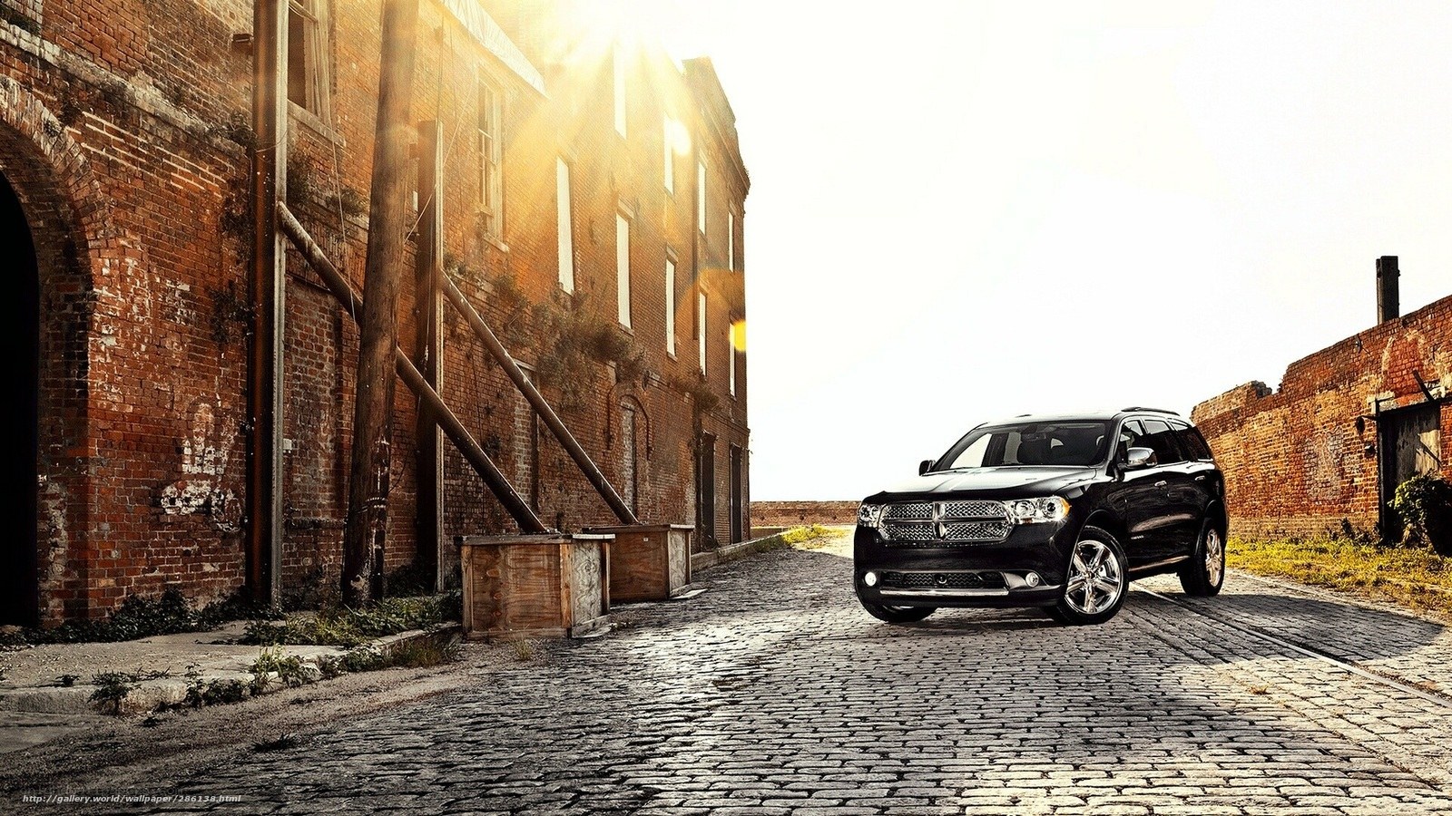 Black SUV on cobblestone street