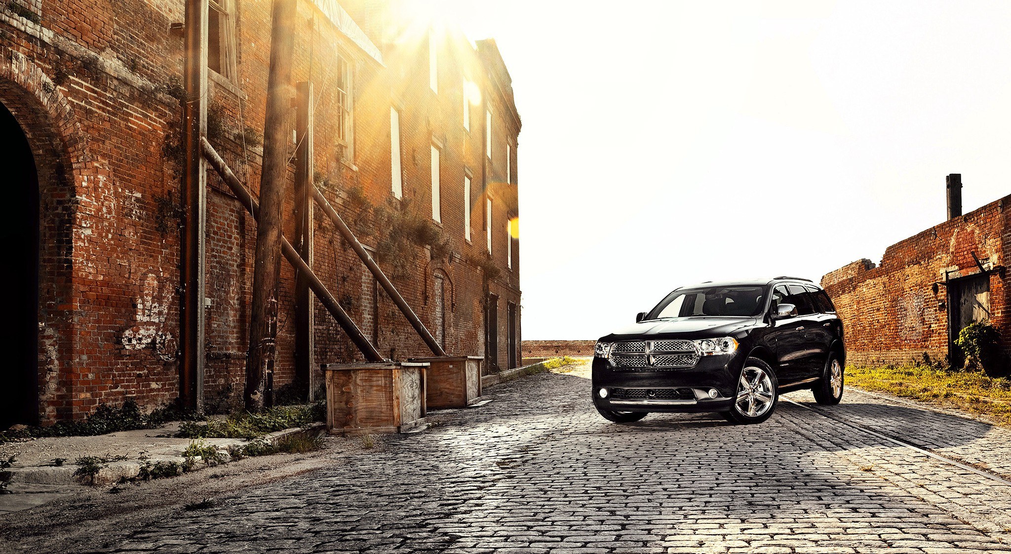 Black SUV on cobblestone street