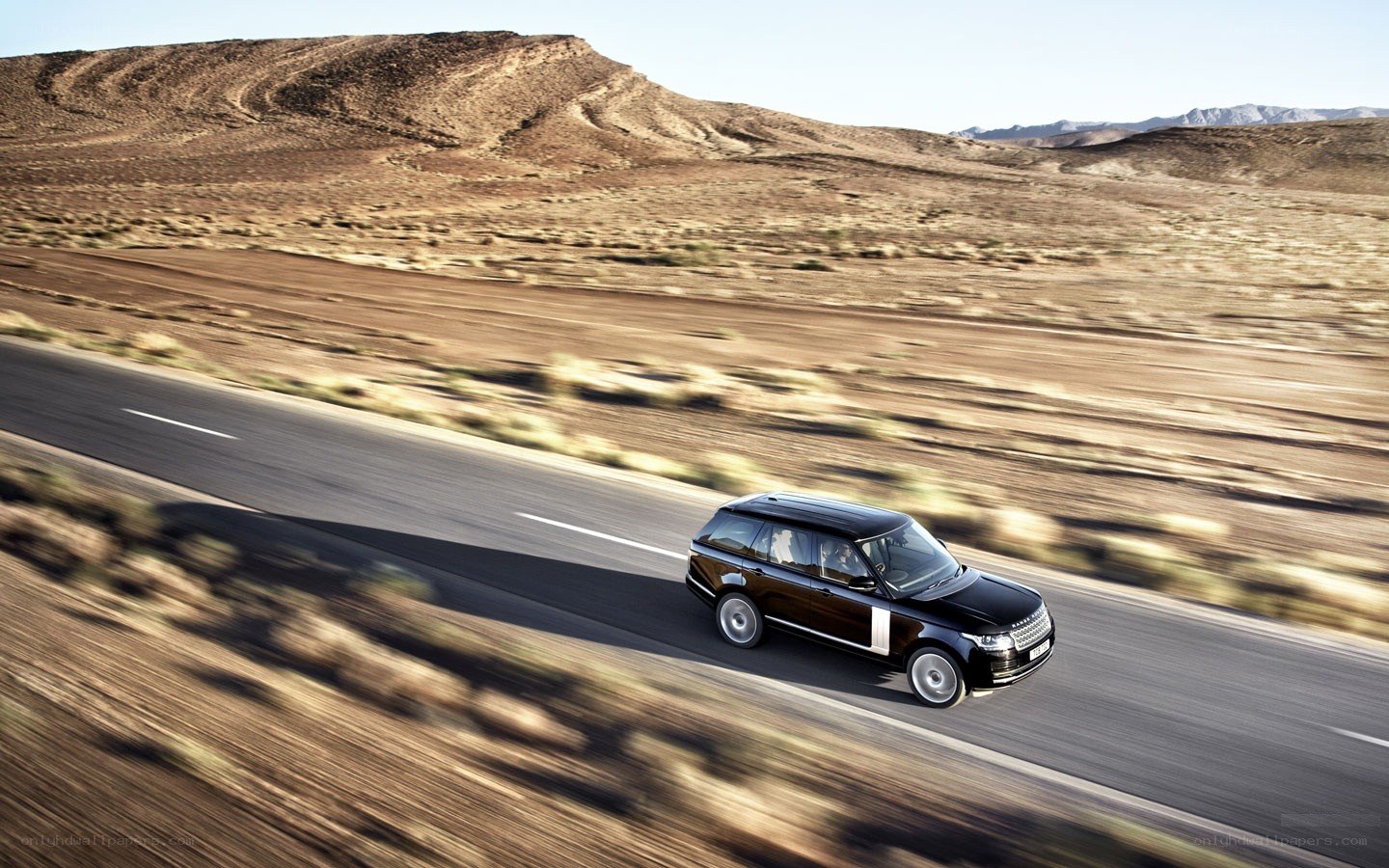 Black SUV on desert road