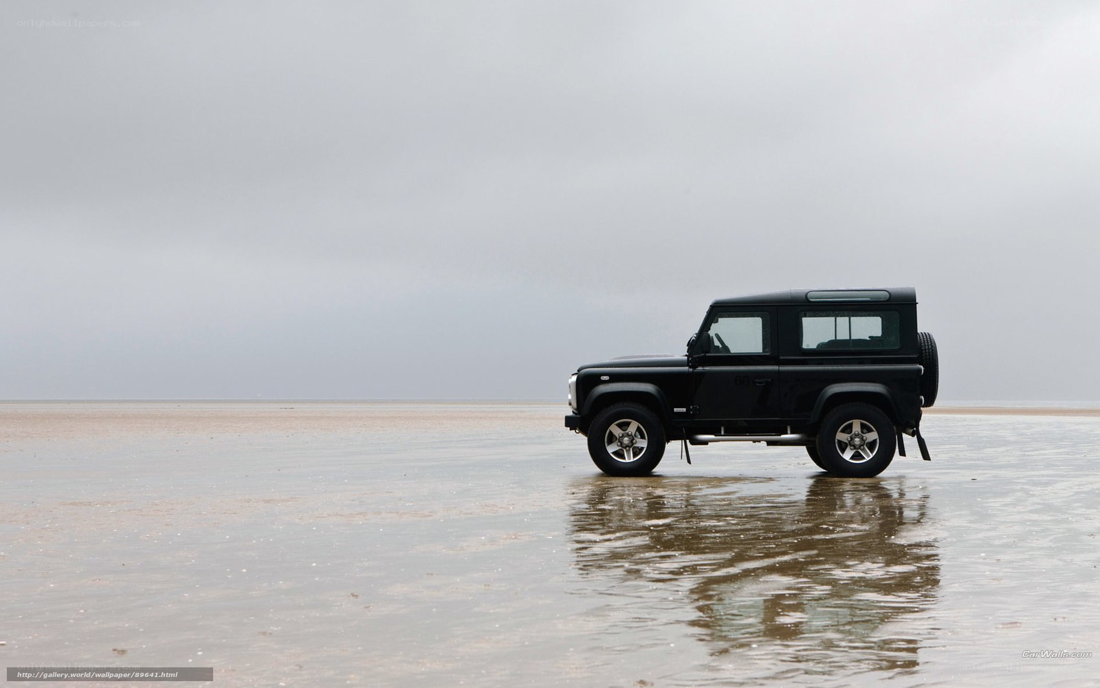 Black SUV on wet beach