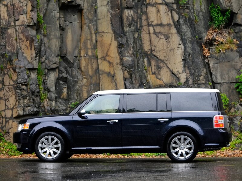 black SUV parked by rock wall