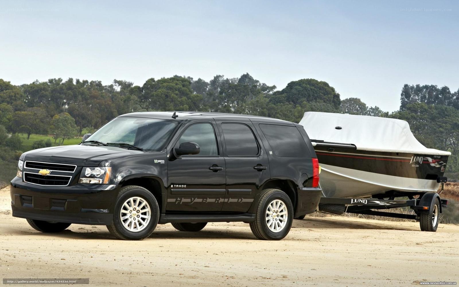 Black SUV towing boat