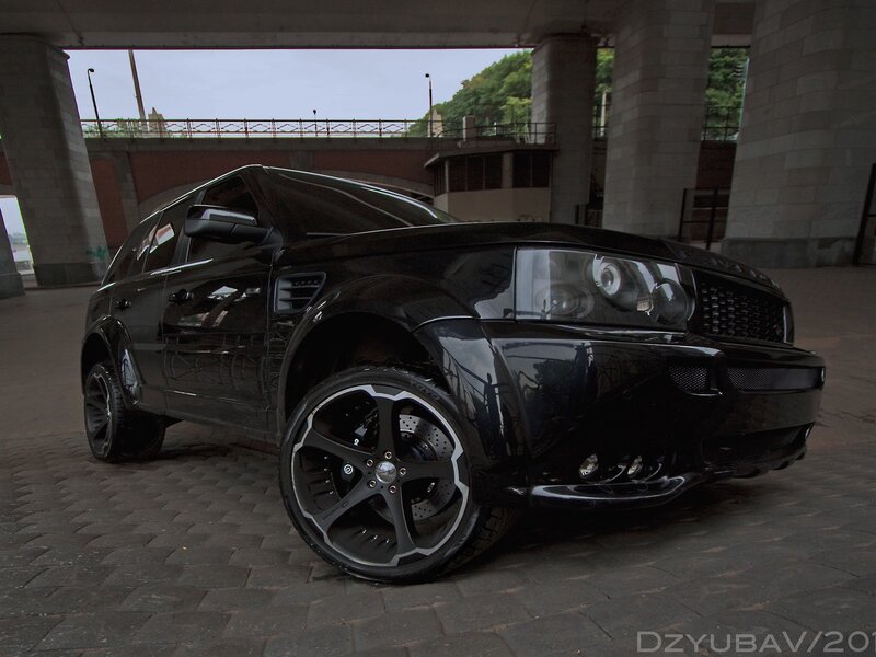 Black SUV under Bridge — Dramatic