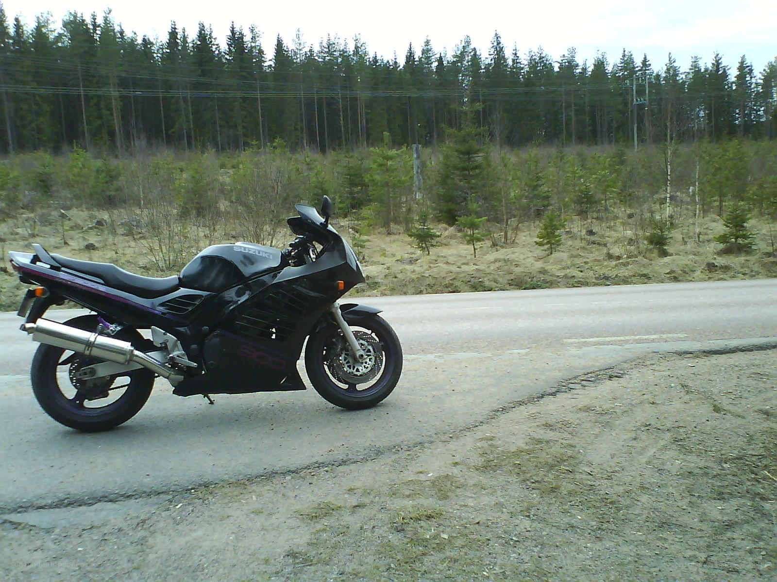 Black Suzuki motorcycle on roadside