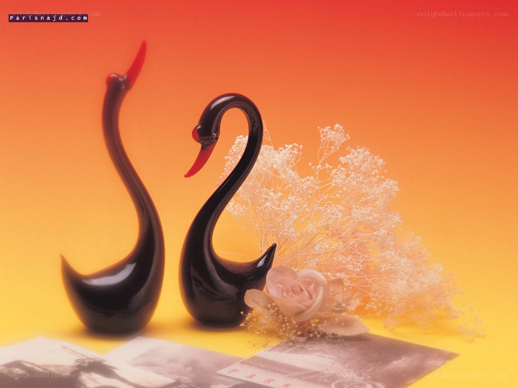 Black swan figurines with flowers