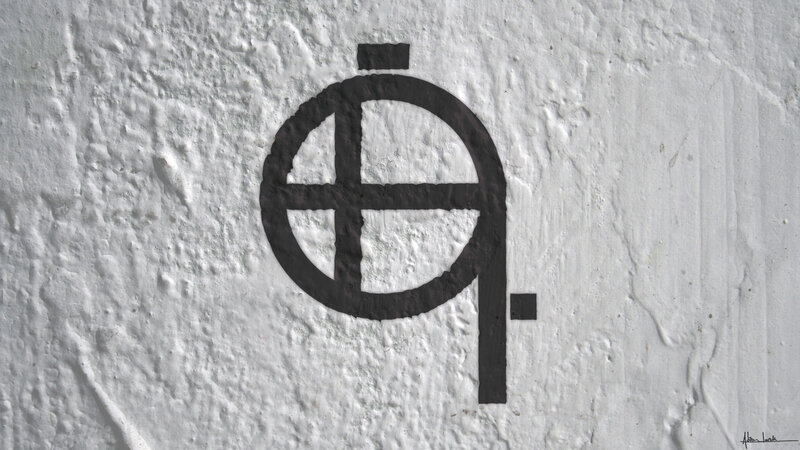 black symbol on white wall