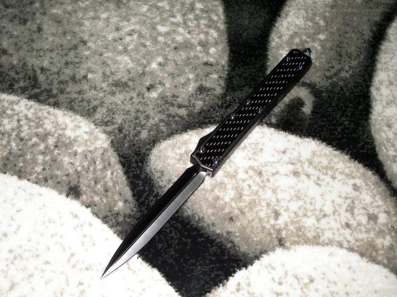 black tactical knife on carpet