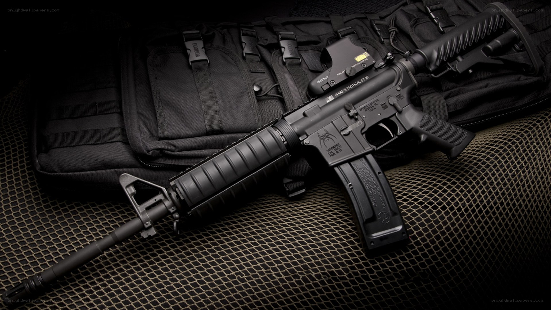 Black tactical rifle on mesh
