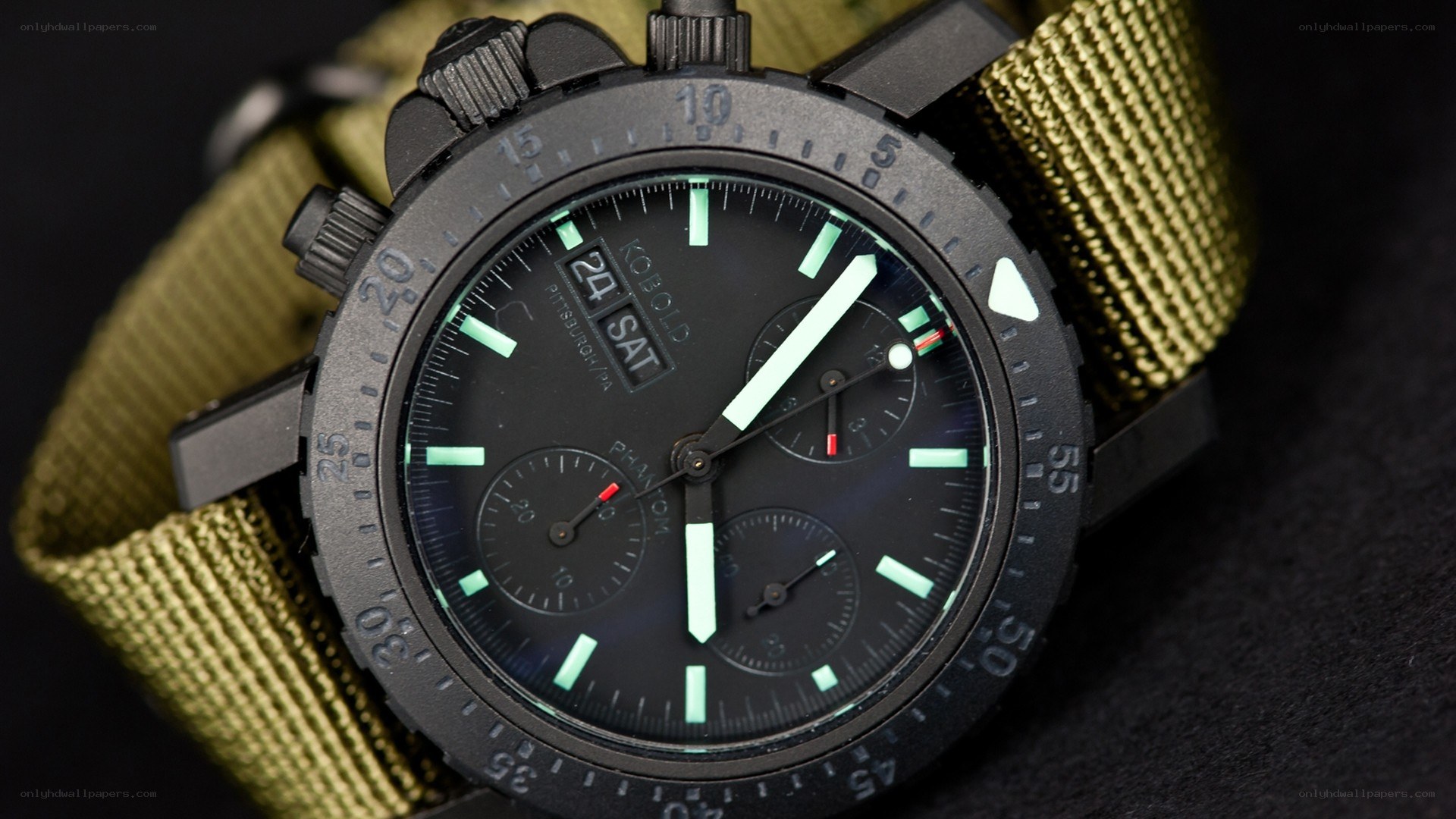 black tactical watch with green strap