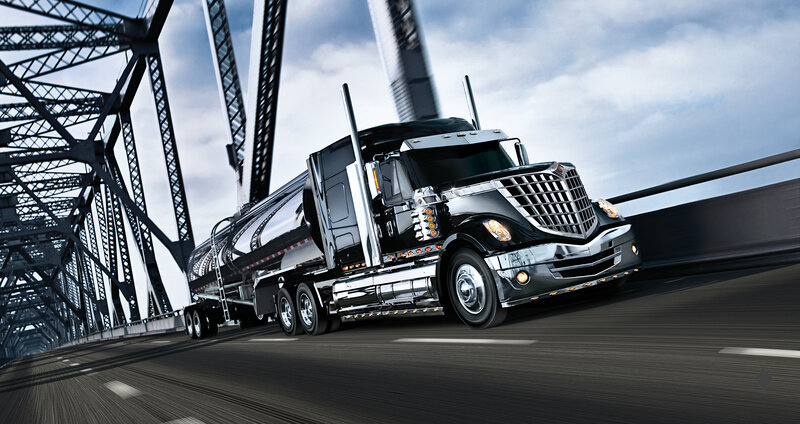 Black tanker truck on bridge