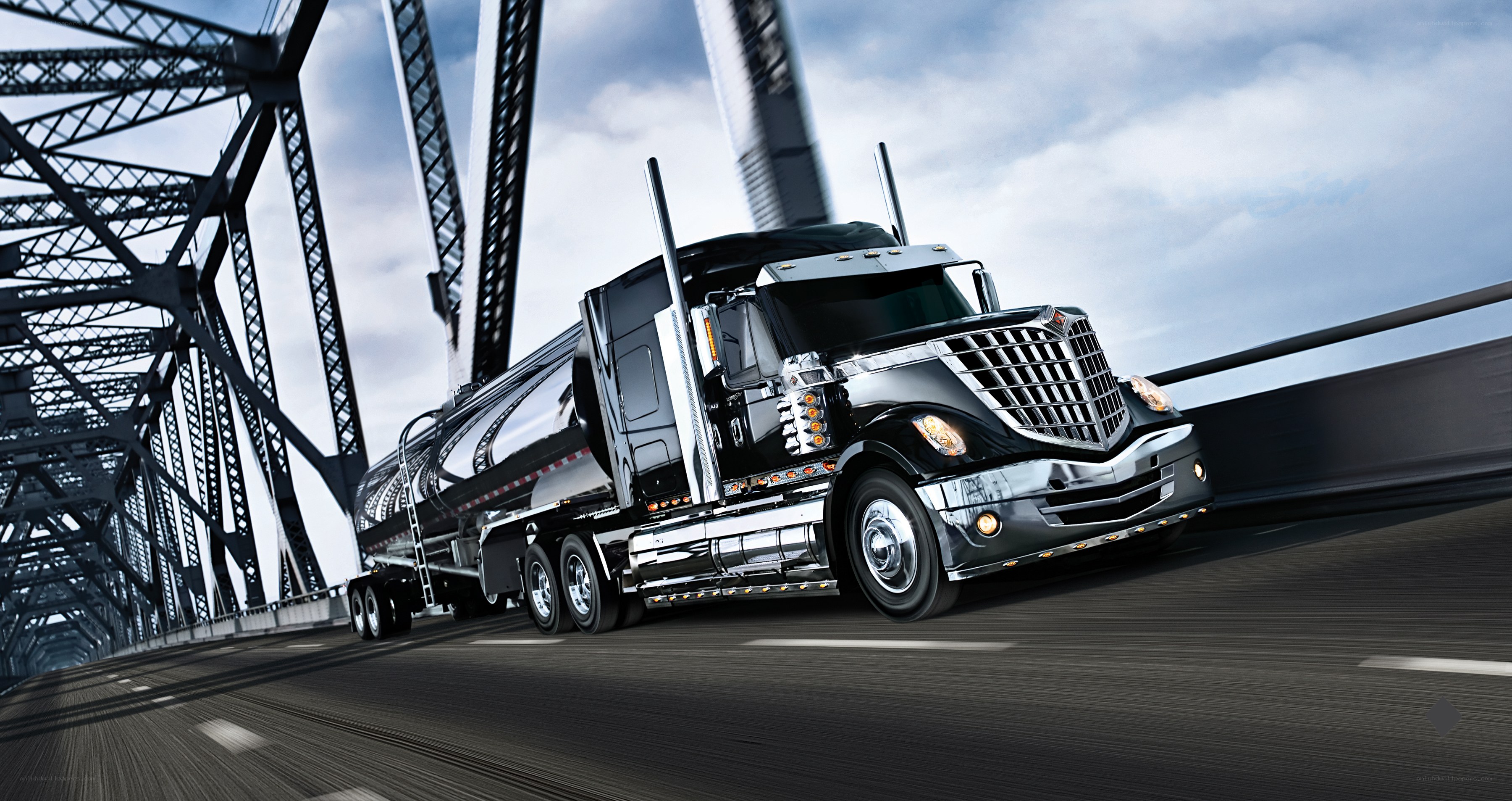 Black tanker truck on bridge