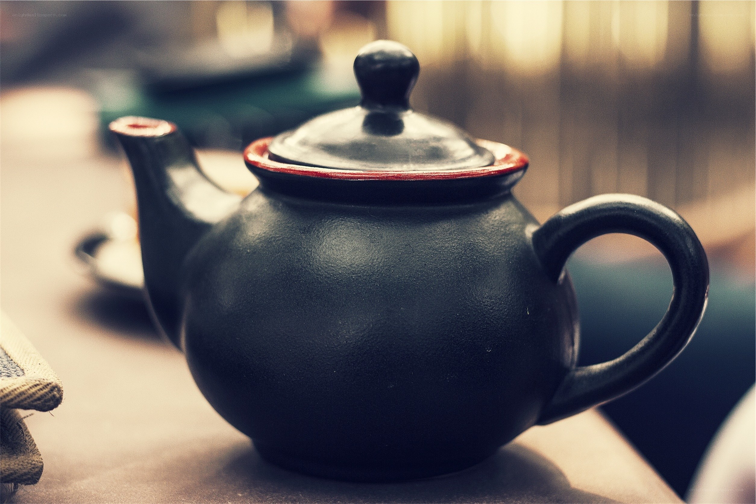 Black teapot with red trim
