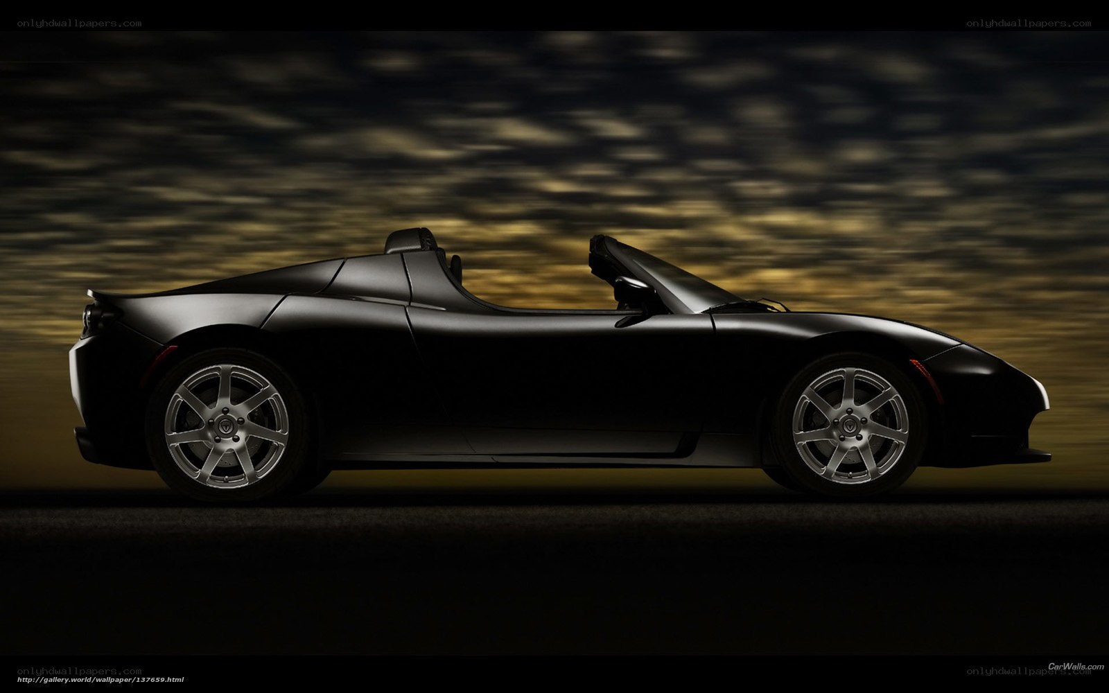 black tesla roadster at night