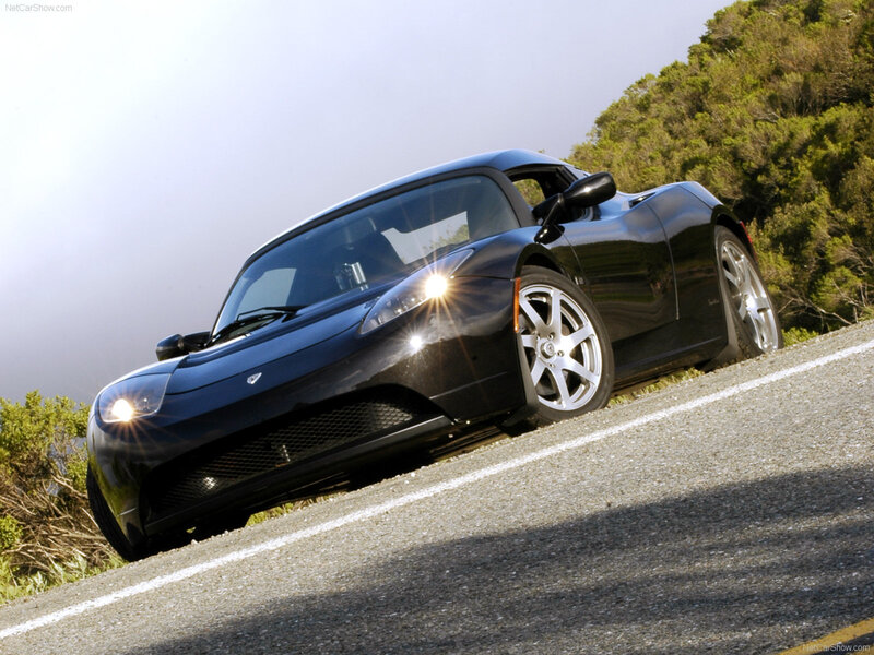 black tesla roadster on winding road