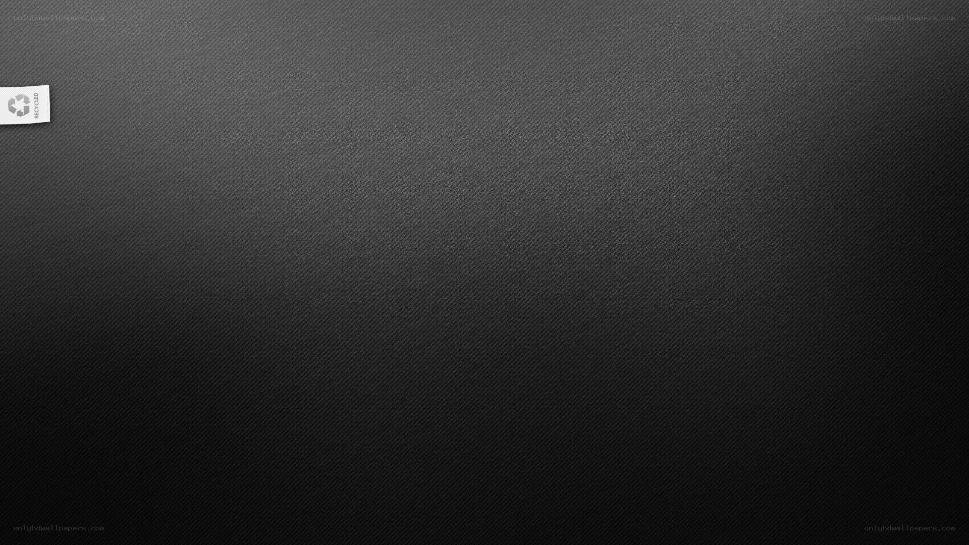 black textured surface with recycle label
