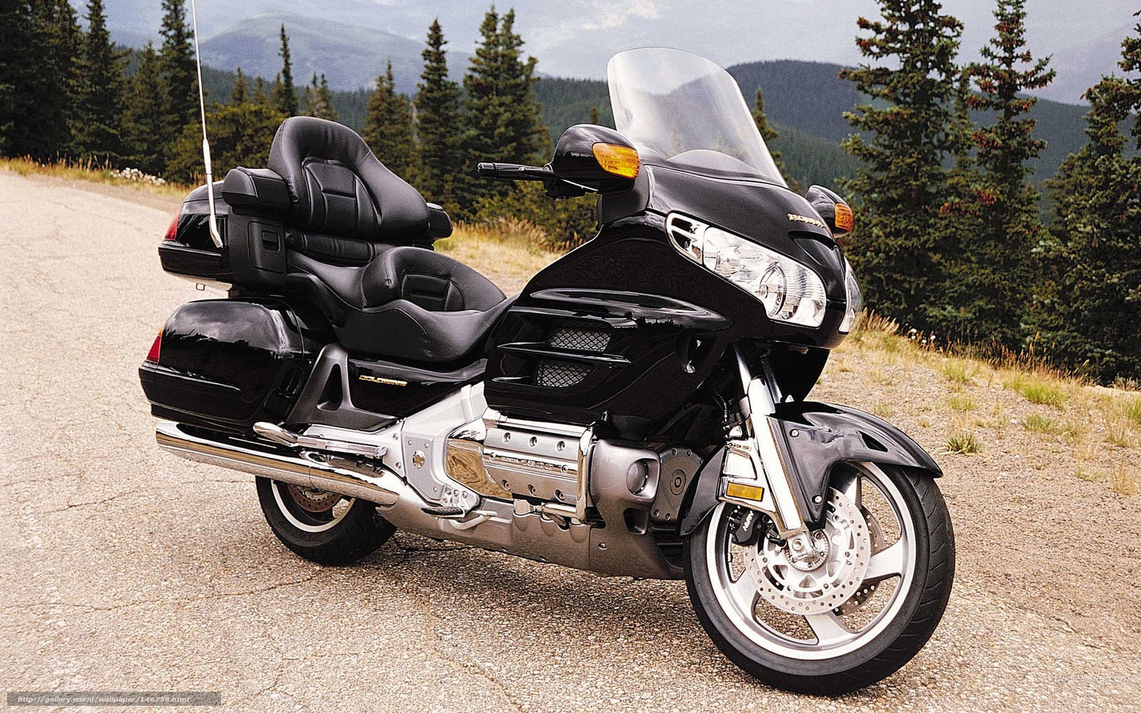 black touring motorcycle on mountain road