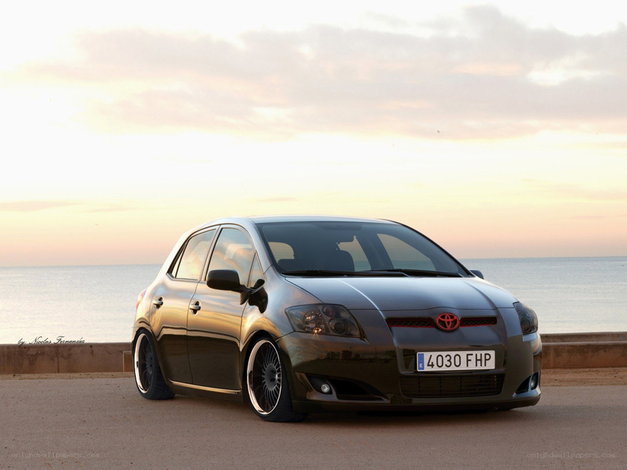 Black Toyota Corolla at sunset
