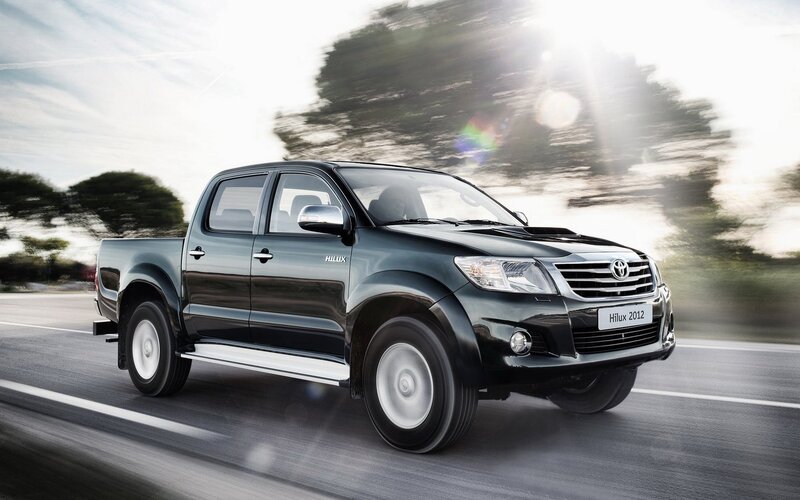 Black Toyota Hilux in motion