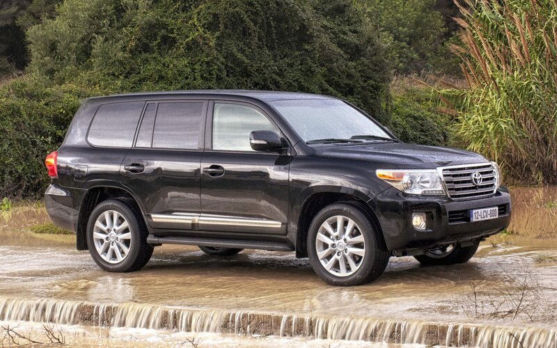Black Toyota Land Cruiser crossing water