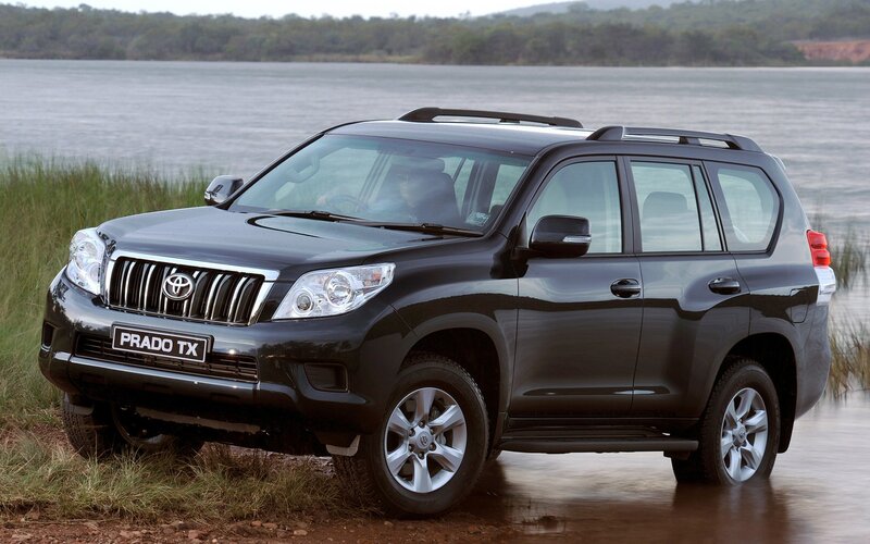 Black Toyota Prado by a lake
