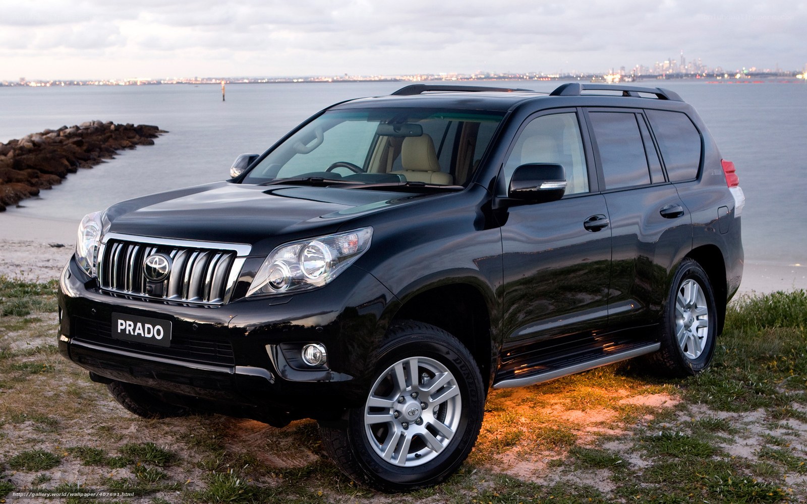 Black Toyota Prado by the water