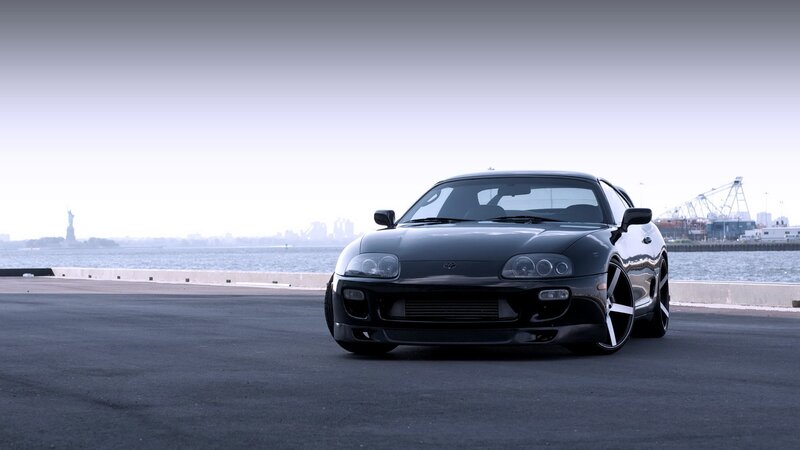 Black Toyota Supra by the water