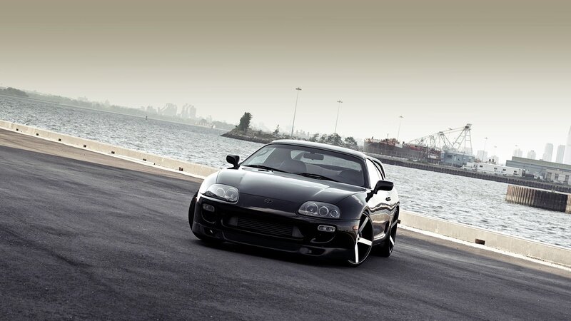 Black Toyota Supra by the water
