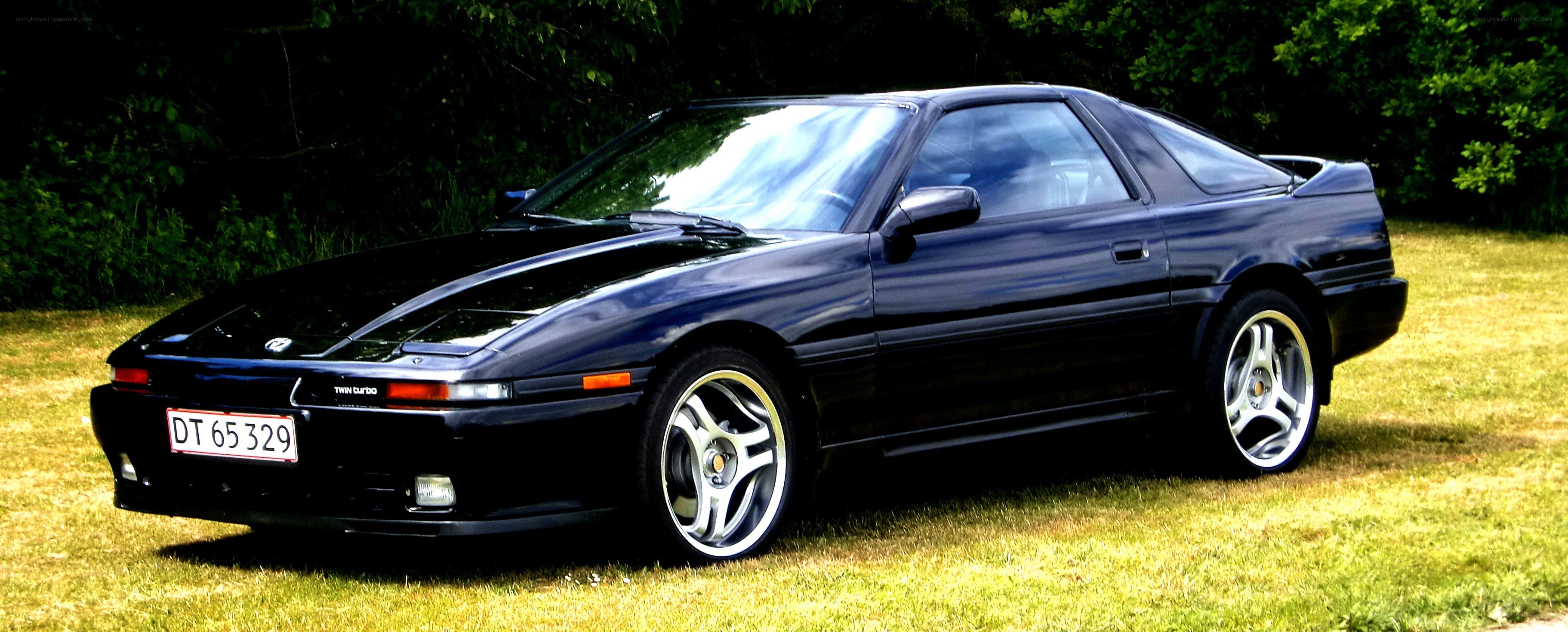 black toyota supra on grass