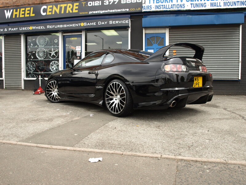 Black Toyota Supra outside wheel shop