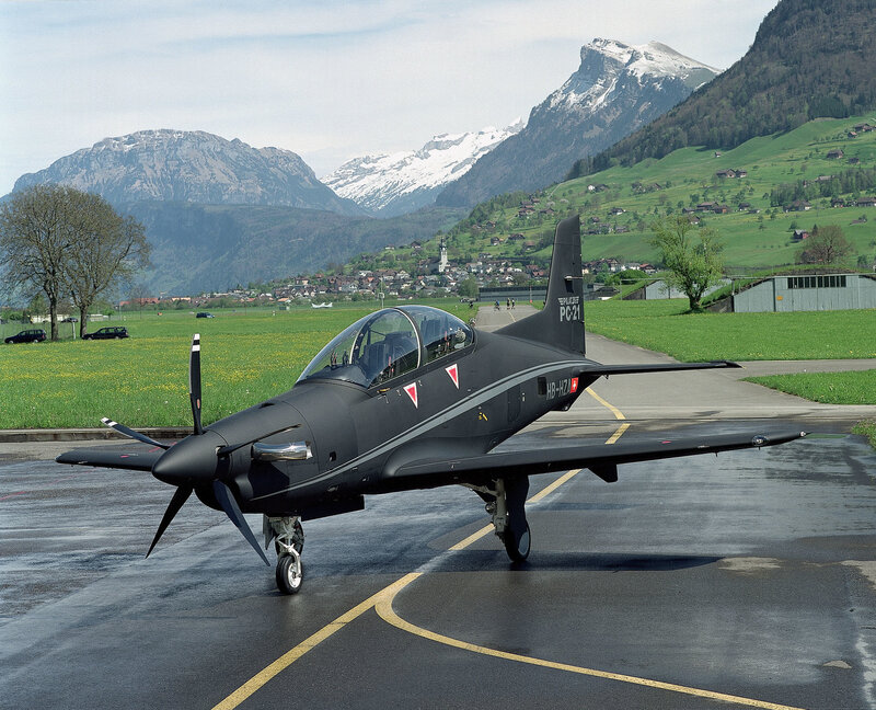 Black training aircraft on tarmac