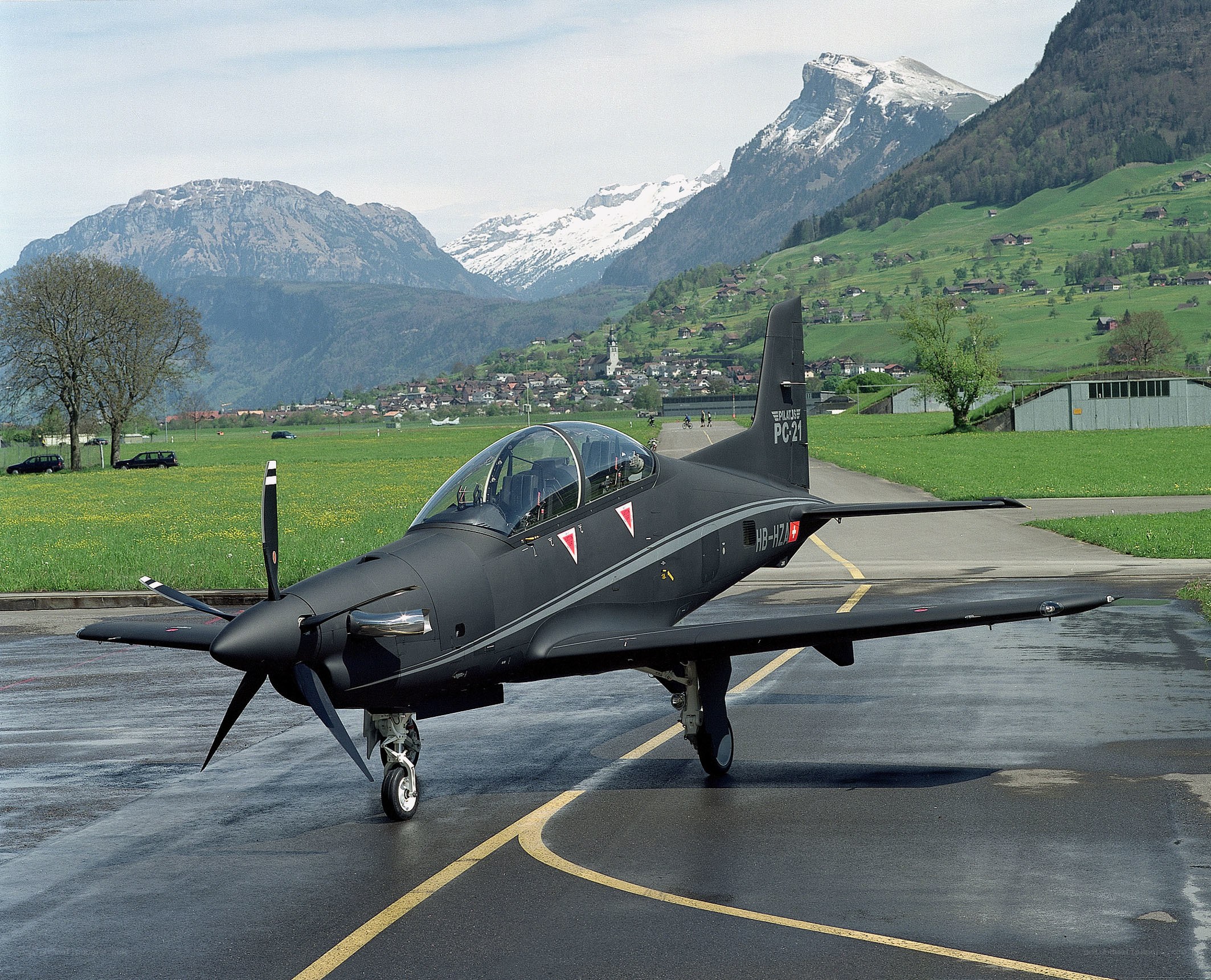 Black training aircraft on tarmac
