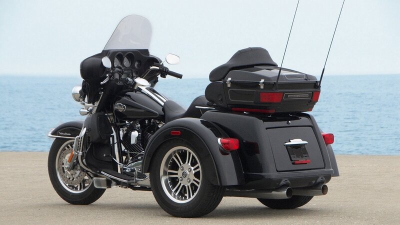 black trike motorcycle by the sea