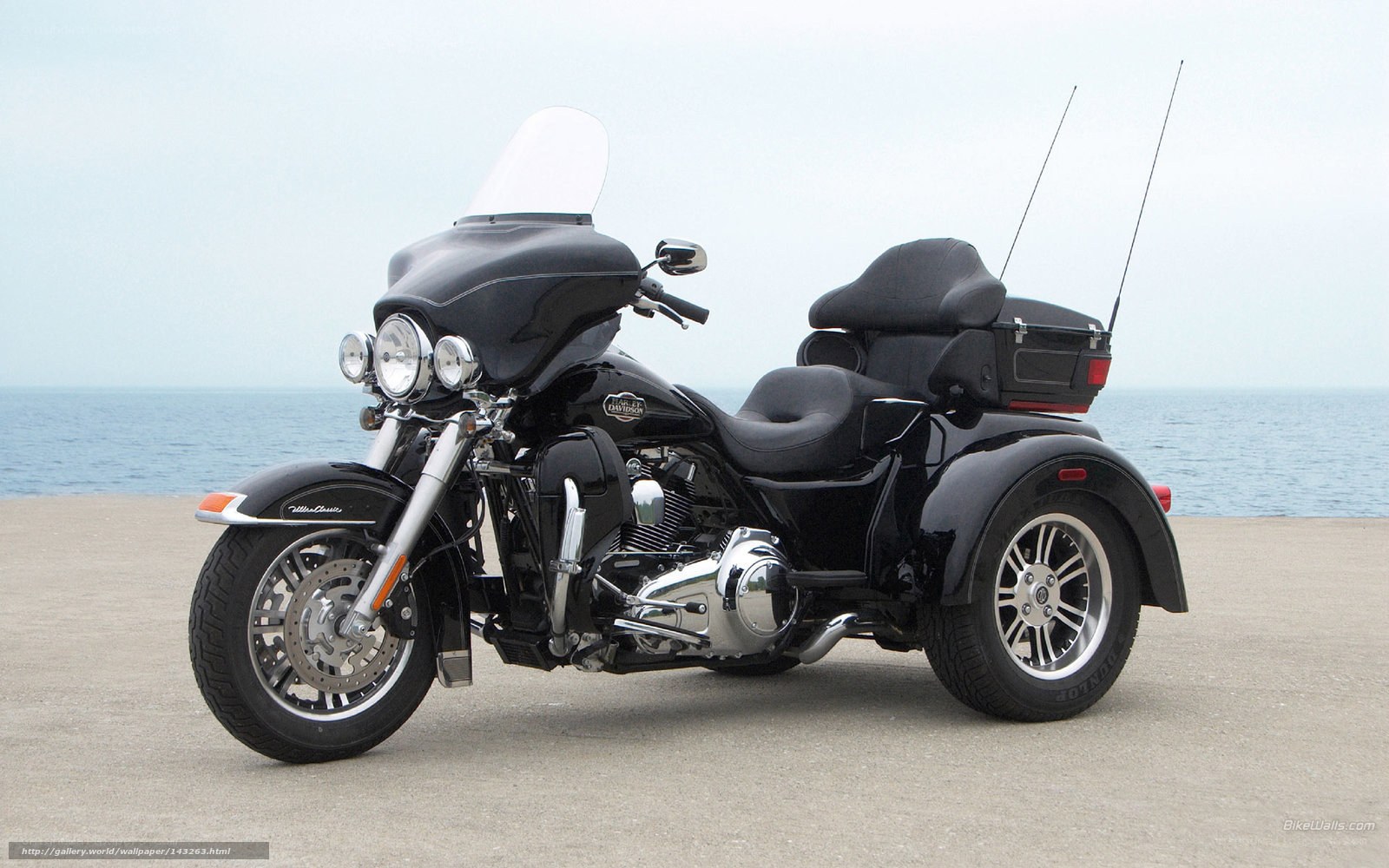 black trike motorcycle by the sea