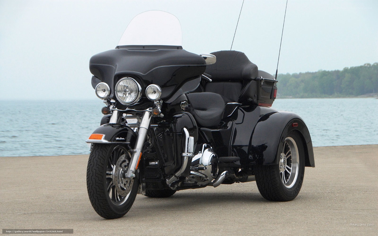 black trike motorcycle by water