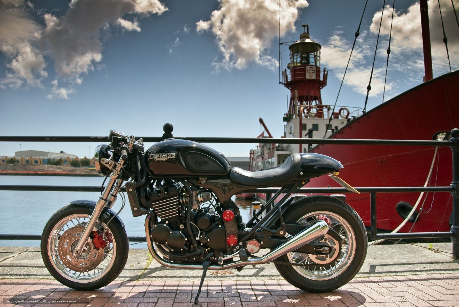 Black Triumph motorcycle at harbor