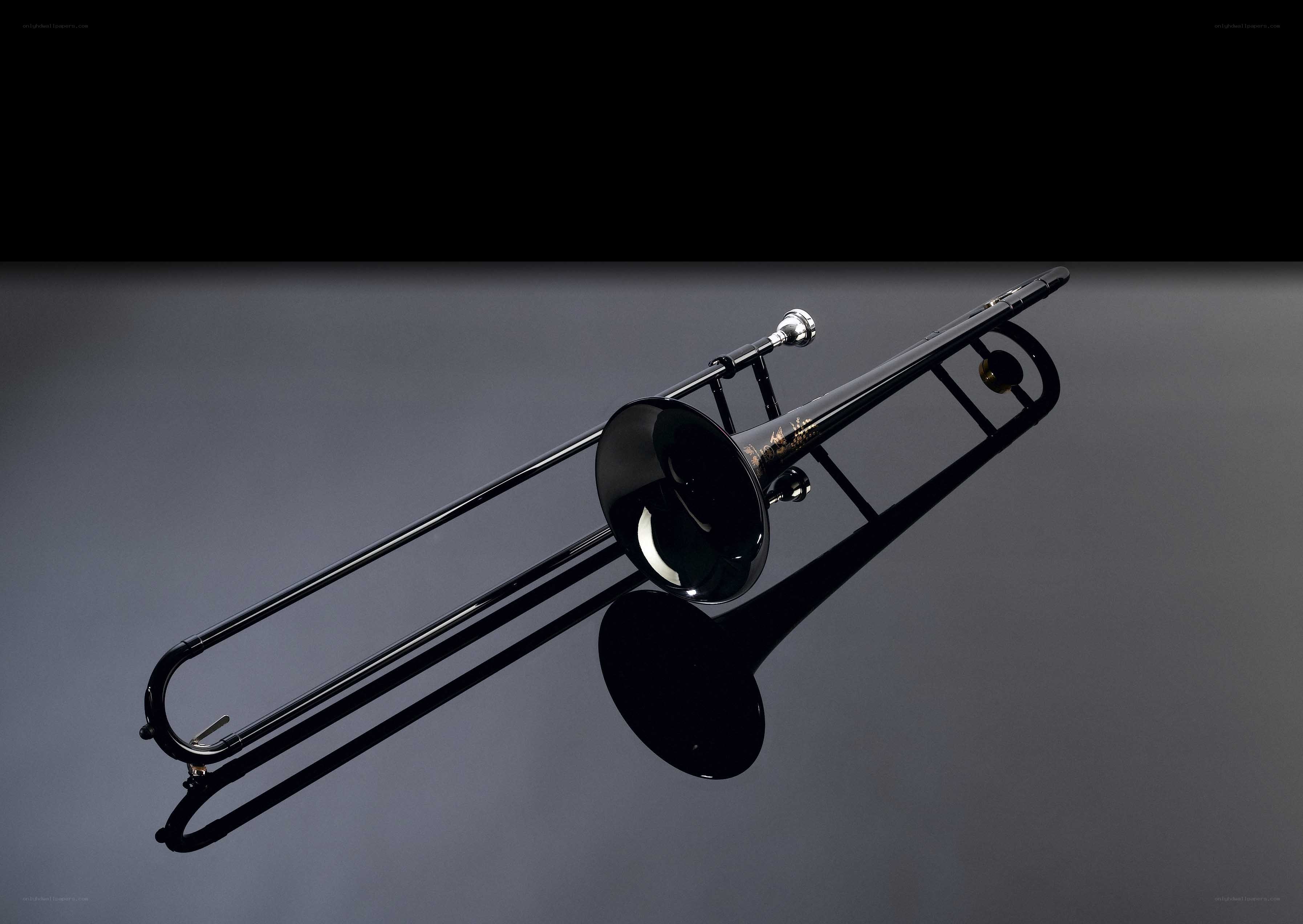 black trombone on reflective surface